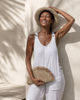 Village Thrive Seagrass Half Moon Clutch handcrafted from natural seagrass with a frayed edge design.
