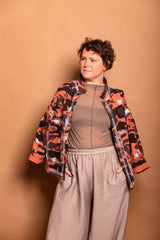 Studio portrait showing the open front styling of the Sherbet orange Japanese twill Studio Jacket over a neutral base.