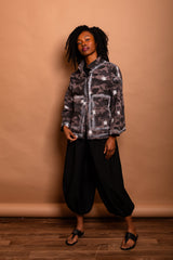 Full-length view of a model wearing the Mushroom grey/black camouflage Studio Jacket with hands in pockets.