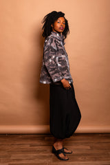 Profile side view of a model wearing the dark Mushroom grey Trompe-l'œil Studio Jacket highlighting sleeve length and boxy cropped cut.