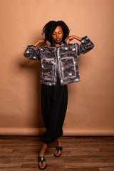Front view portrait of the model holding the popped collar of the Mushroom grey Japanese twill Studio Jacket.