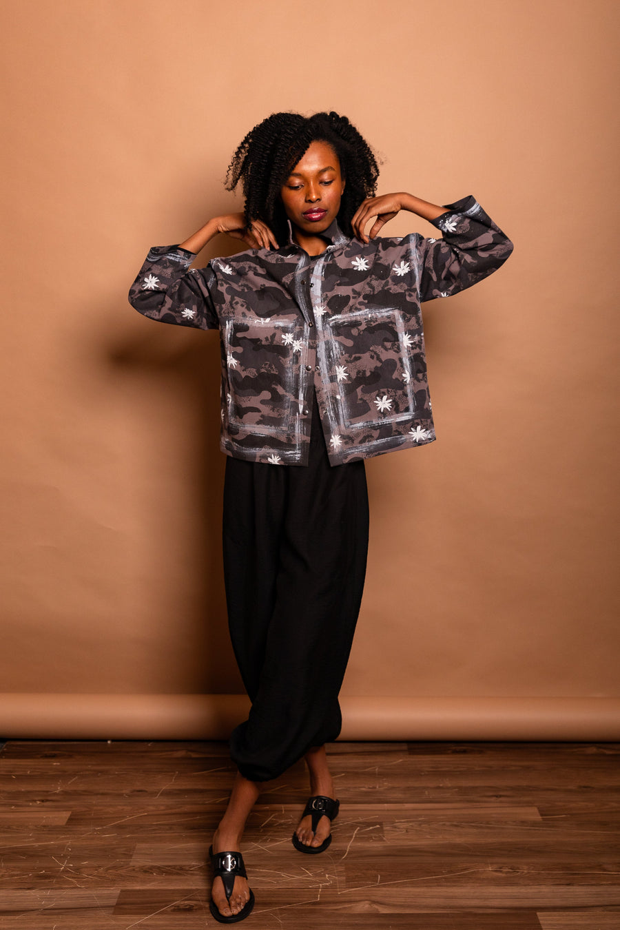 Front view portrait of the model holding the popped collar of the Mushroom grey Japanese twill Studio Jacket.