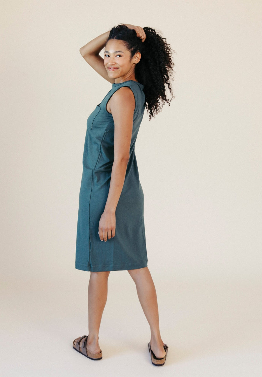 Side profile view showcasing the sleeveless tank cut, relaxed fit, and knee-length hem of the Pine green jersey dress.