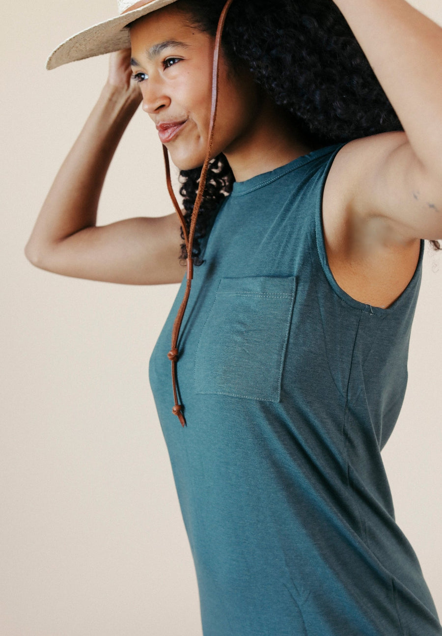 Close-up detail shot focusing on the upper left chest pocket and relaxed ribbed crew neck.