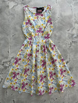 Flat lay product view of the Retrolicious Wildflower vintage cotton dress on a marble background showing the full flared skirt.