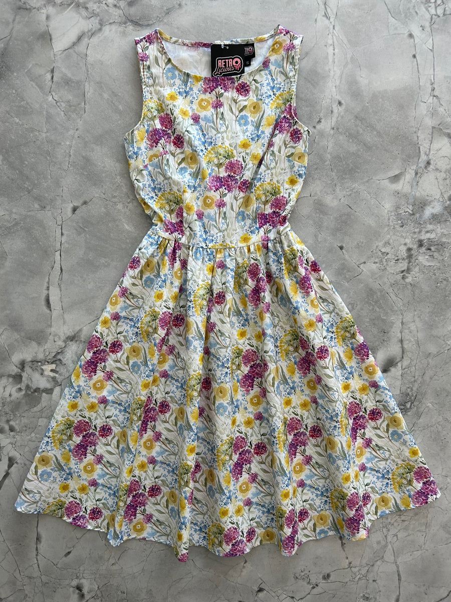Flat lay product view of the Retrolicious Wildflower vintage cotton dress on a marble background showing the full flared skirt.