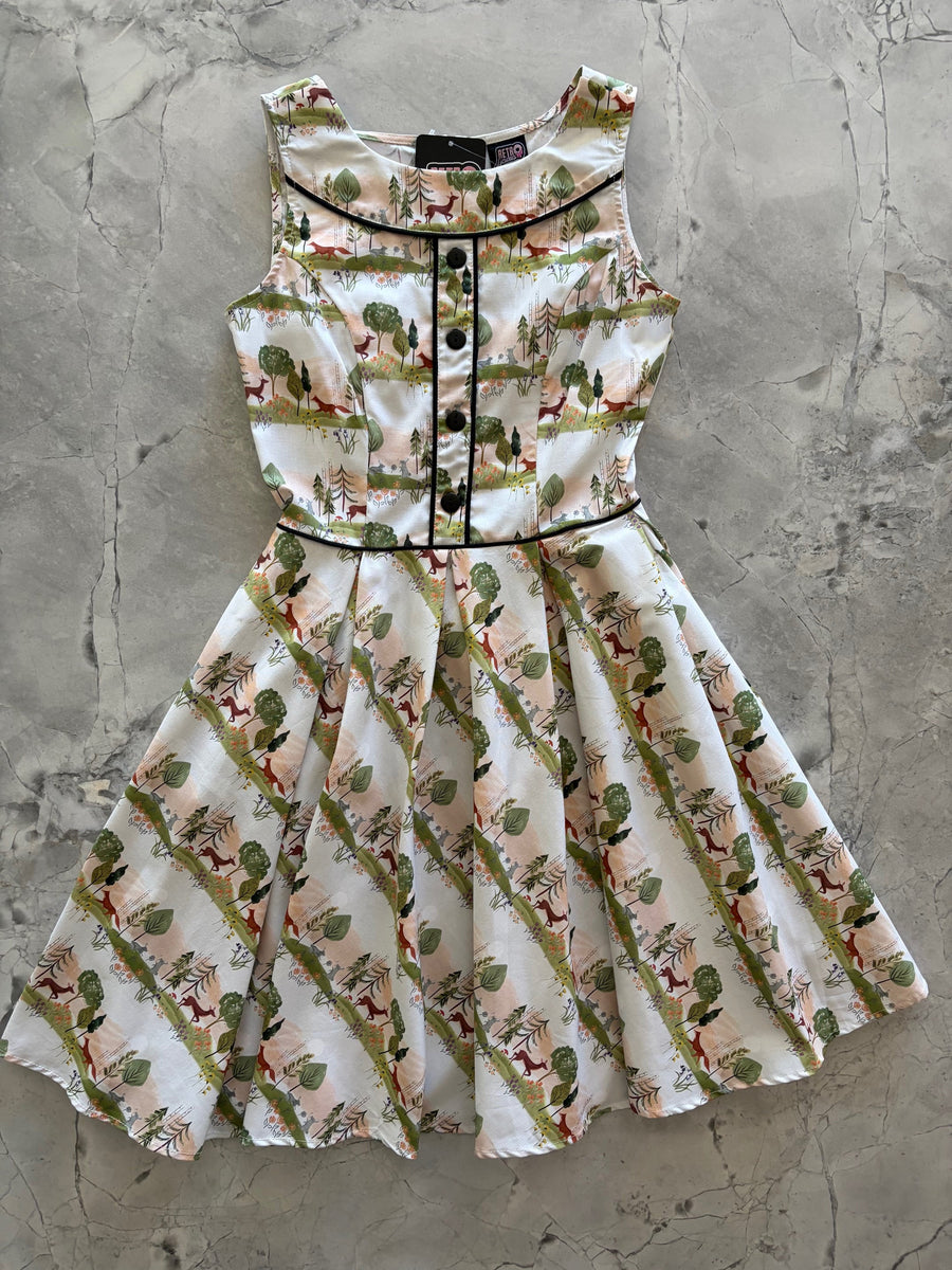 Flat lay product photo of the Retrolicious Elizabeth Dress in Woodland Sunset print on a gray marble background showing the full pleated skirt.