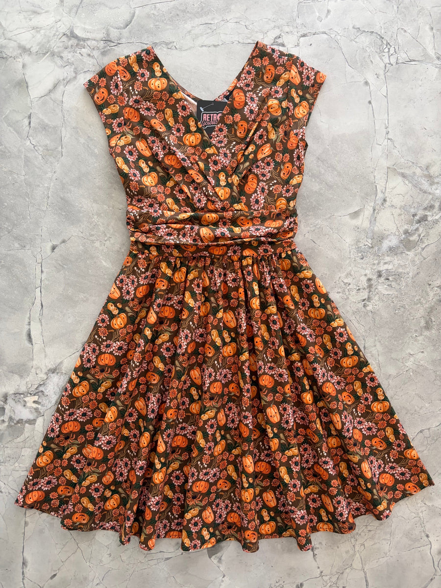 Flat lay product photograph of the Retrolicious Pumpkins & Flowers Greta Dress on a grey marble background