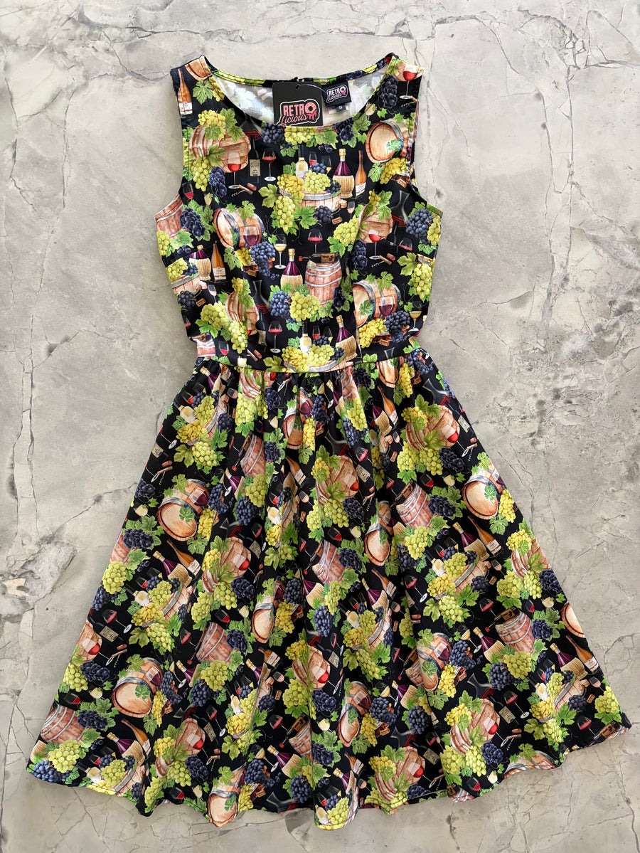 Flat lay photo of the Retrolicious Wine Vintage Dress showing its fitted bodice, sleeveless armholes, and full pleated skirt.