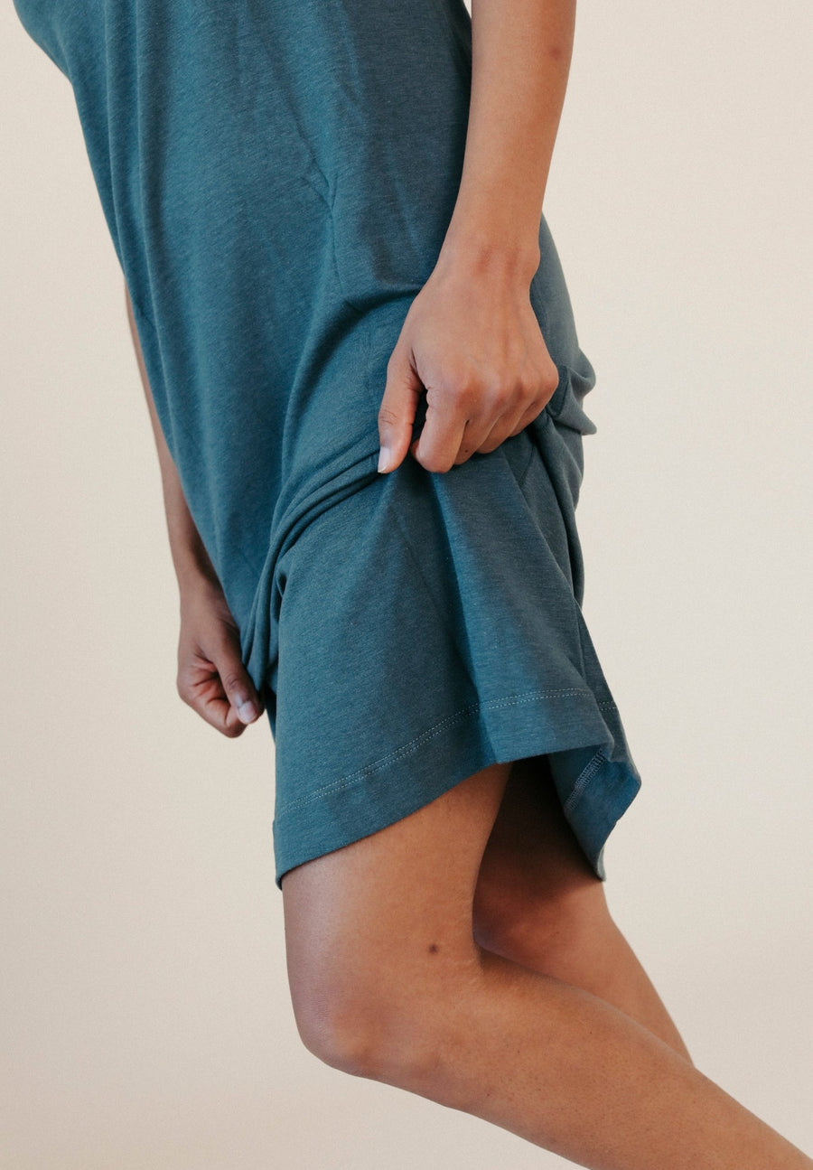Action close-up detail highlighting the right side slit and soft texture of the TENCEL™ organic cotton jersey fabric.