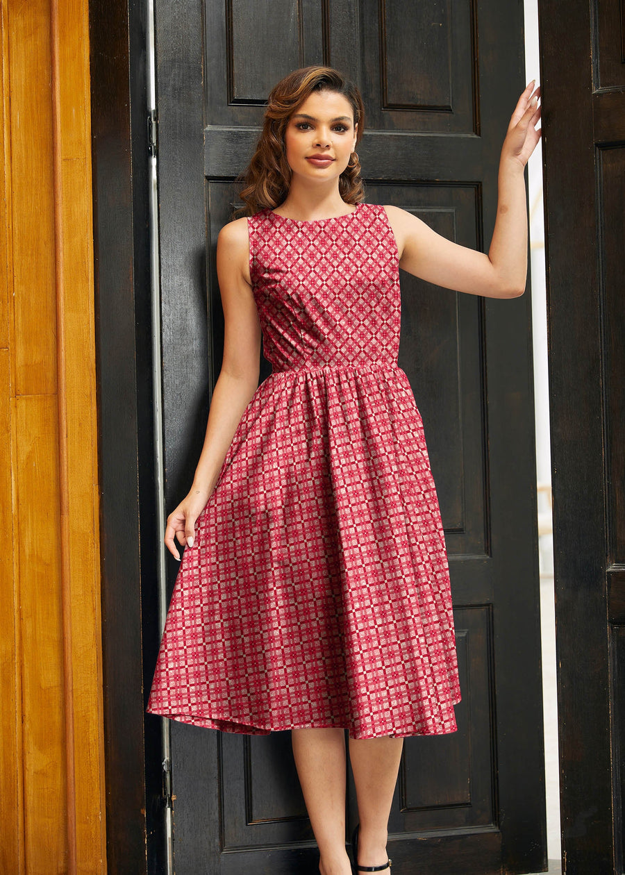 Medium full-length studio portrait of a brunette model posing in a doorway wearing the Retrolicious Red Diamond Midi Dress.