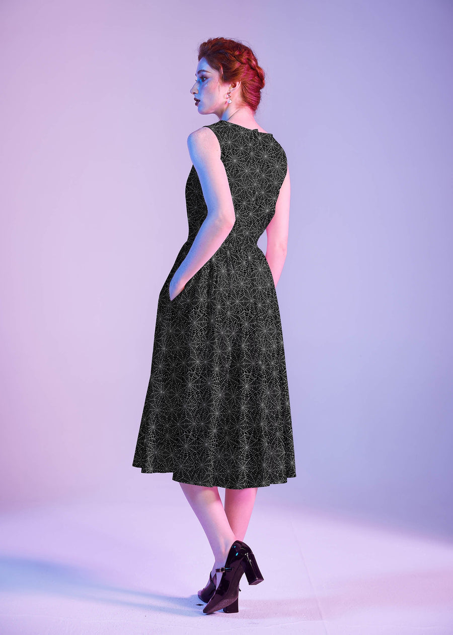 Three-quarter back perspective of the model showing the back profile, hidden side pocket placement, and midi swing length.