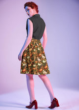 Three-quarter back perspective showing the back waistband and fit of the Retrolicious A-line Skirt.