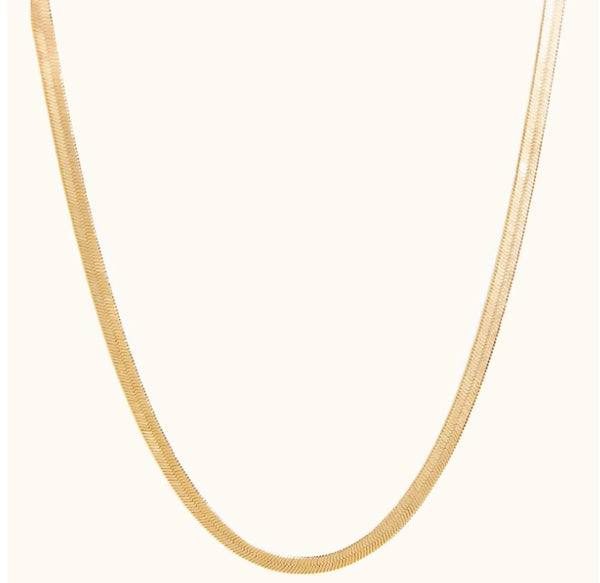 Able A sleek gold herringbone chain necklace by ABLE displayed in a classic curved layout against a clean cream background