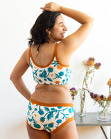 Three-quarter rear view showing the scoop back fit and underarm coverage of the Robben's Artichokes organic cotton longline bra.