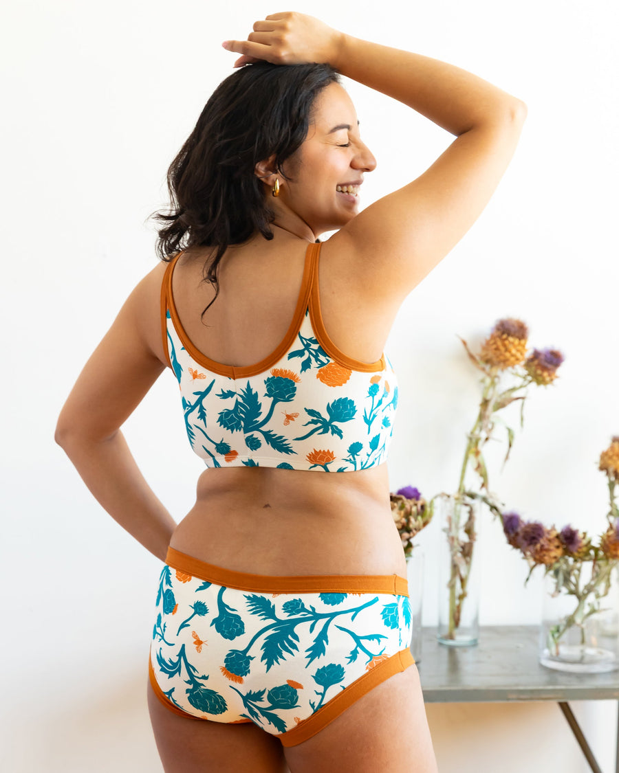 Three-quarter rear view showing the scoop back fit and underarm coverage of the Robben's Artichokes organic cotton longline bra.