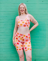 Front view of a model wearing Thunderpants High Rise Bike Shorts in the 90s celestial Luna y Sol sun and moon print.