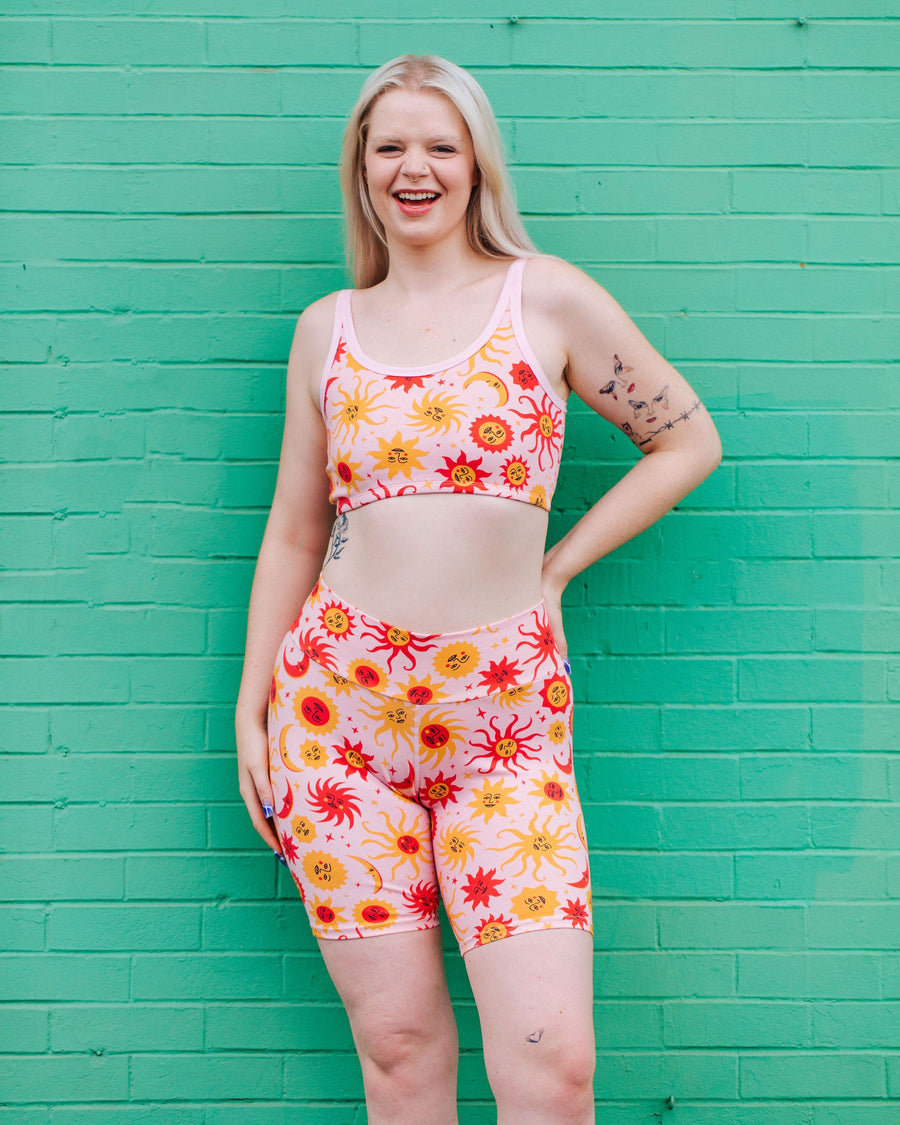 Front view of a model wearing Thunderpants High Rise Bike Shorts in the 90s celestial Luna y Sol sun and moon print.