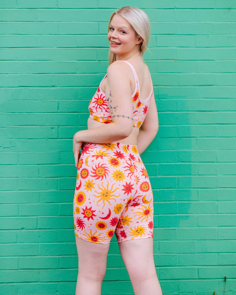 Side view of a model wearing Thunderpants High Rise Bike Shorts in the 90s celestial Luna y Sol sun and moon print.