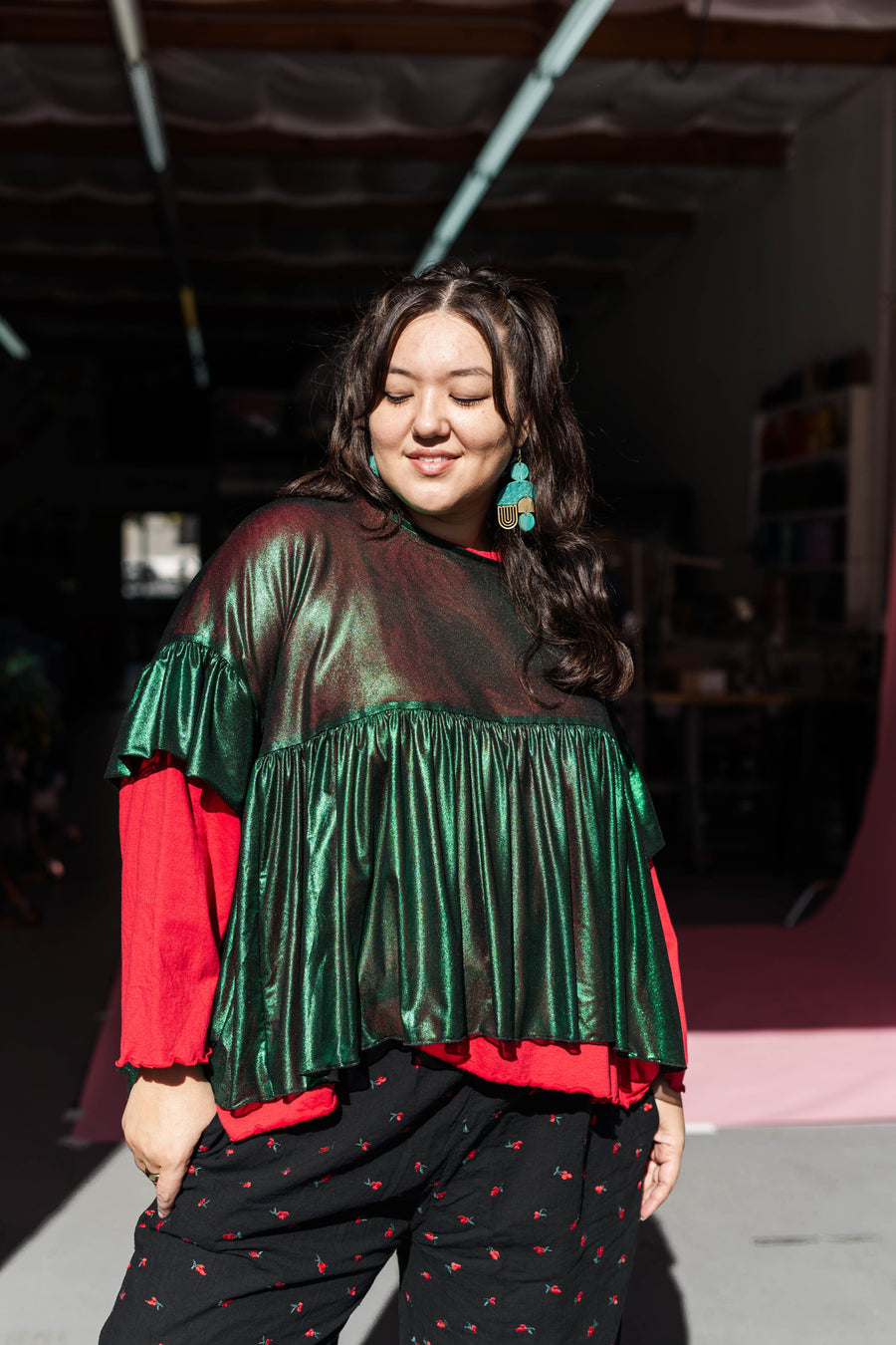 Outdoor studio portrait showing the shimmer, drape, and texture of the Nettle Studios Green Tinsel Mushroom Top.