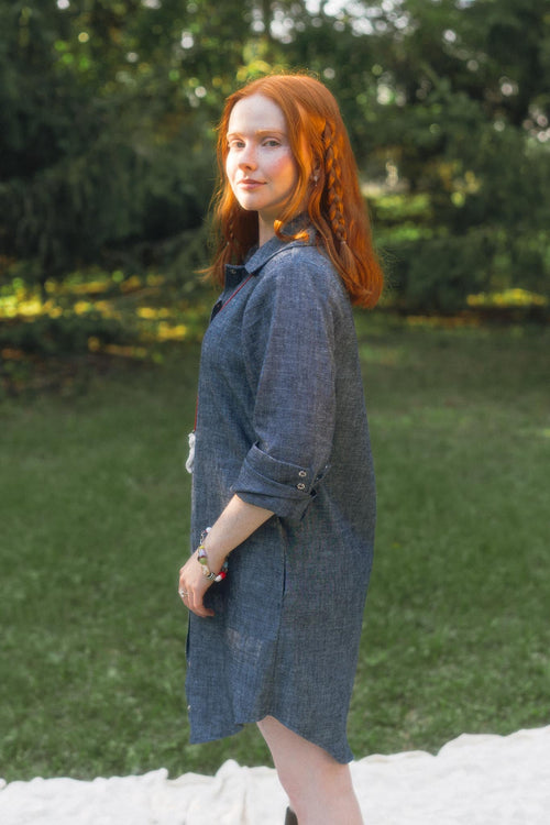 Side profile view of model Bronwyn wearing the oversized hemp organic cotton Aurelia Shirt Dress in Indigo Chambray.