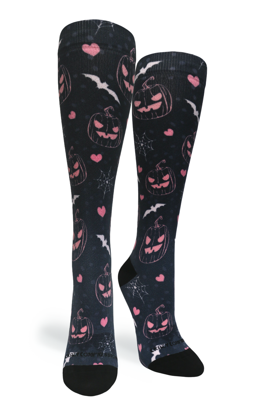 Studio portrait shot of a pair of Jill-O-Lantern knee-high compression socks featuring pink jack-o'-lanterns, hearts, bats, and spiderwebs on black fabric