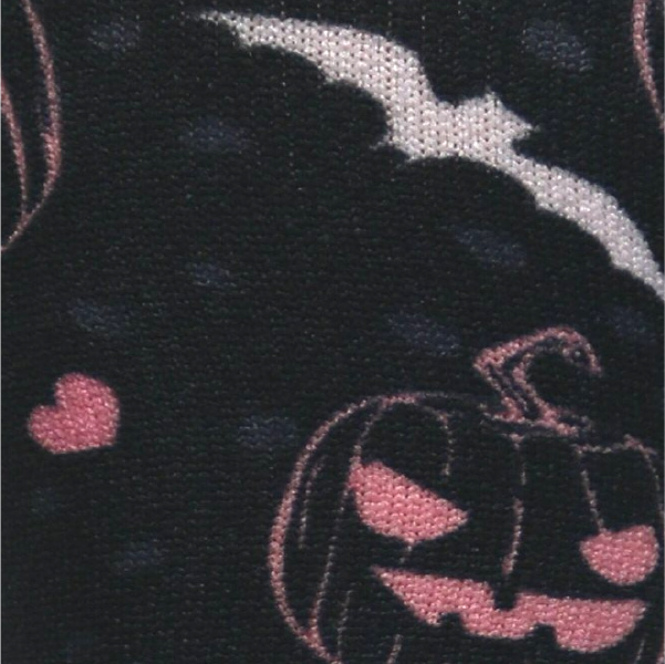 High-resolution close-up fabric shot detailing the knit texture of a pink jack-o'-lantern, heart, and white bat on black material.