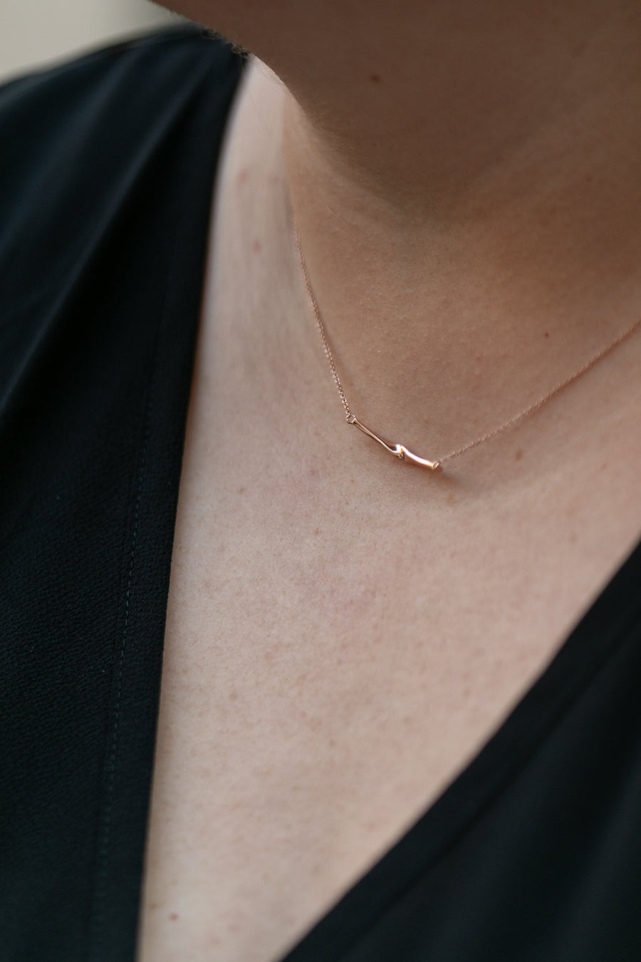 Chouette Designs a close up of a woman's neck wearing a rose gold twist necklace