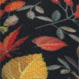 High-resolution fabric swatch detail showing red, yellow, and green autumn leaves knit texture on black base fabric.
