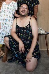 Plus size model wearing the Tamara Malas Gigi Slip Dress in black floral print.