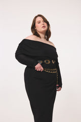 Three-quarter close-up view of a plus-size model highlighting the fold-over elastic neckline, unlined long sleeves, and double-belt styling of the geometric black dress.