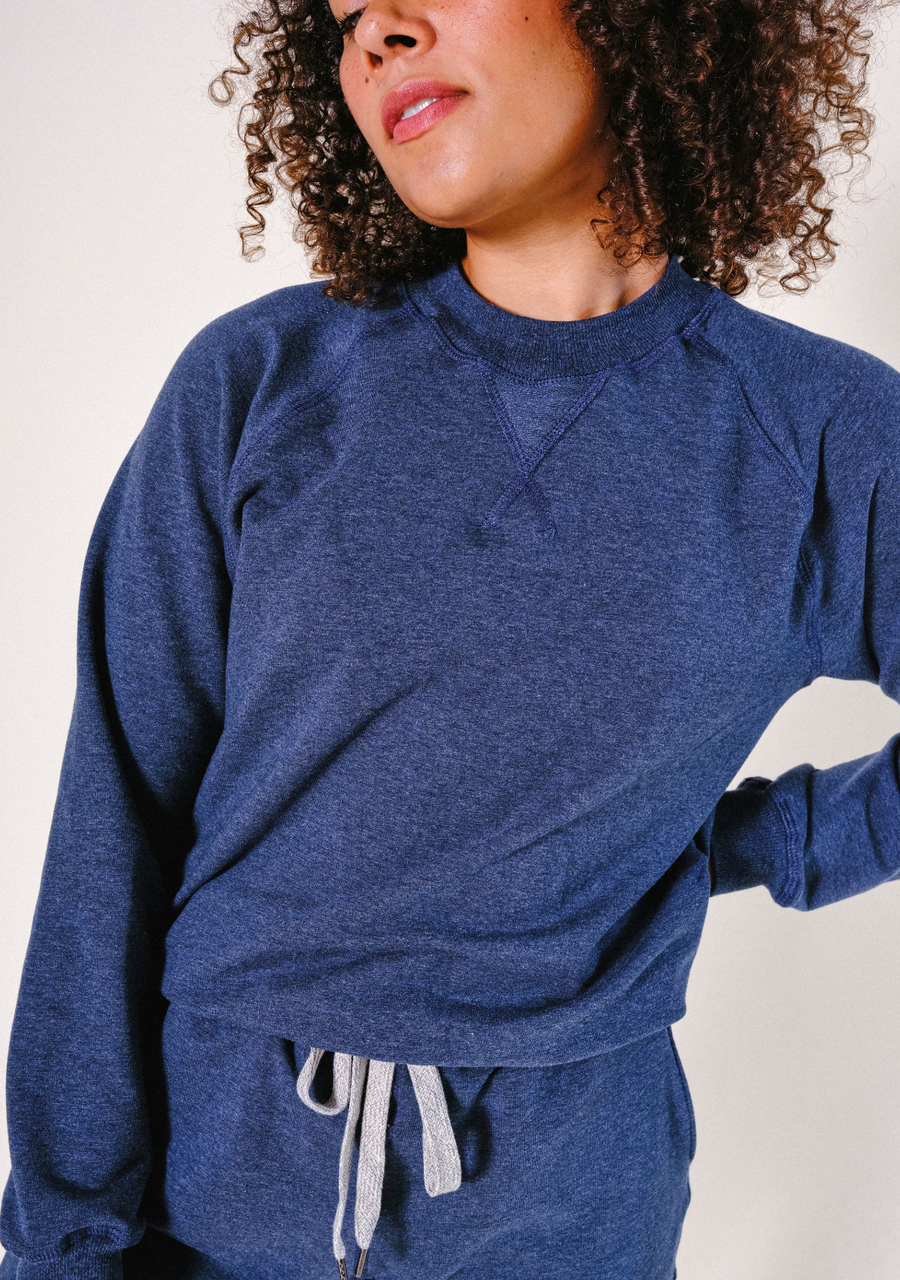 Close-up shot highlighting the ribbed crew neckline and raglan sleeve stitching of the Heather Lake Agnes Sweatshirt.