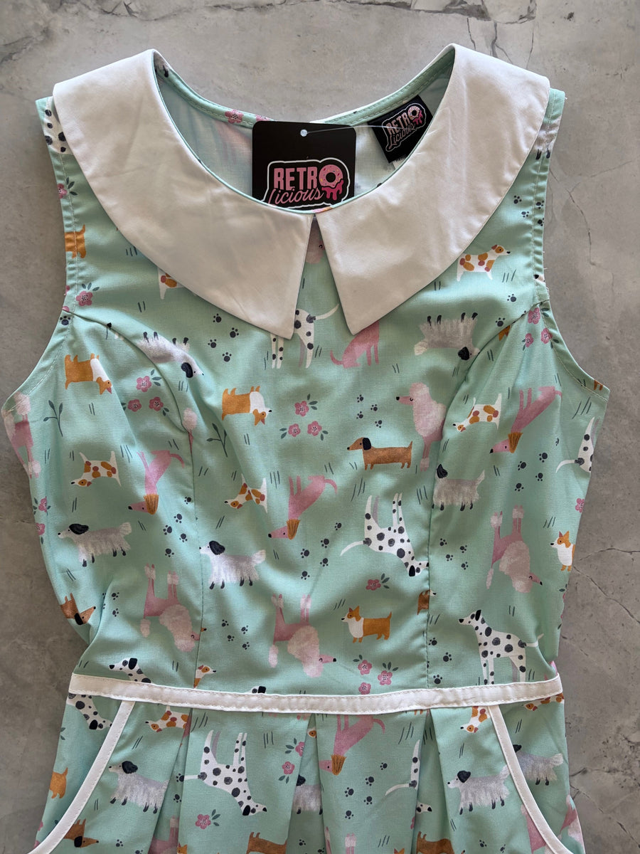 Flat lay detail of the Retrolicious Dogs dress bodice featuring the white contrast Peter Pan collar, waist piping, and brand tag.