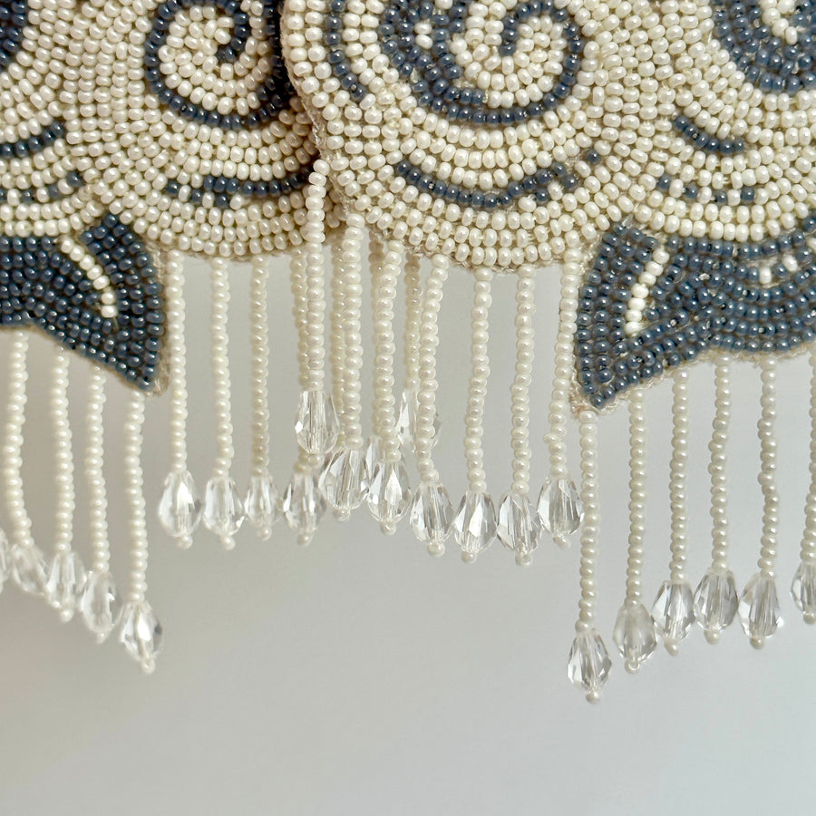 Extreme macro close-up of the delicate glass seed bead swirl patterns and crystal raindrop fringe on the CLOUD earrings.