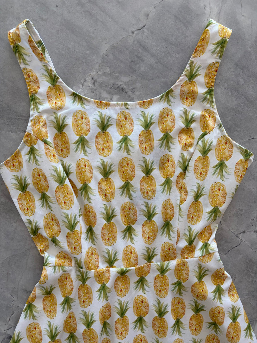 Flat lay detail of the Retrolicious pineapple print dress bodice featuring the scoop front neckline and fitted waist seam.