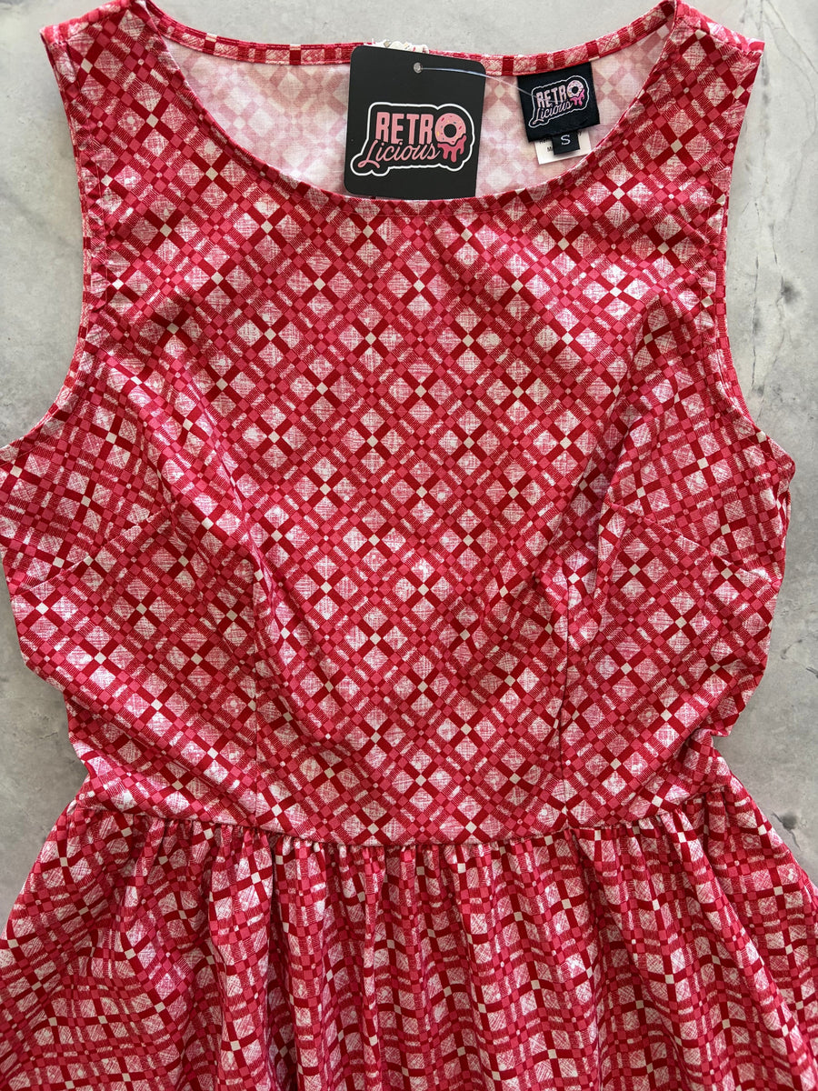 Detailed flat lay photo focusing on the boat neckline and inner brand label of the Red Diamond print dress.