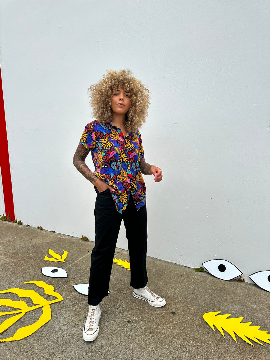 Full-length view of model wearing the relaxed-fit black twill Nooworks painter pants against a plain wall.