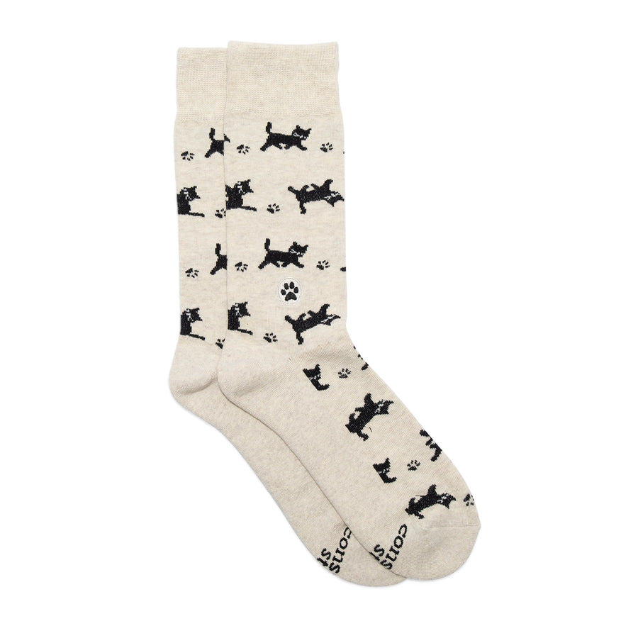 Studio flat lay shot of a pair of Conscious Step Socks That Save Cats showing the full cat print and signature paw embroidery accent.   