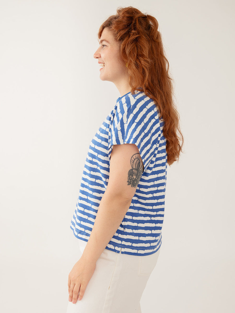 Side profile view of the Caitlin Top showing the drop-shoulder sleeve cut and relaxed boxy waist-length fit.
