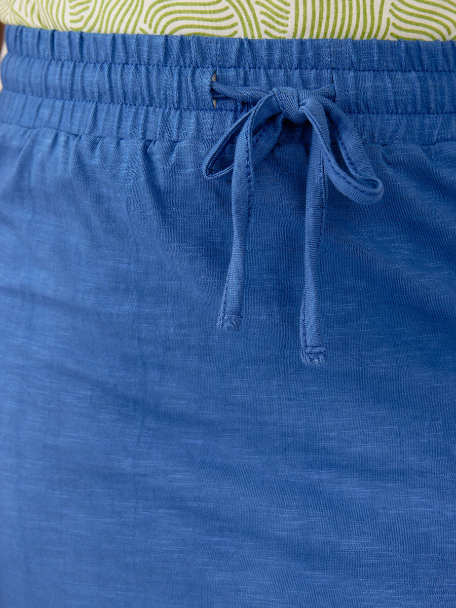 Close-up detail of the elastic drawstring waistband and textured cerulean slub knit cotton fabric of the Isla Skirt.