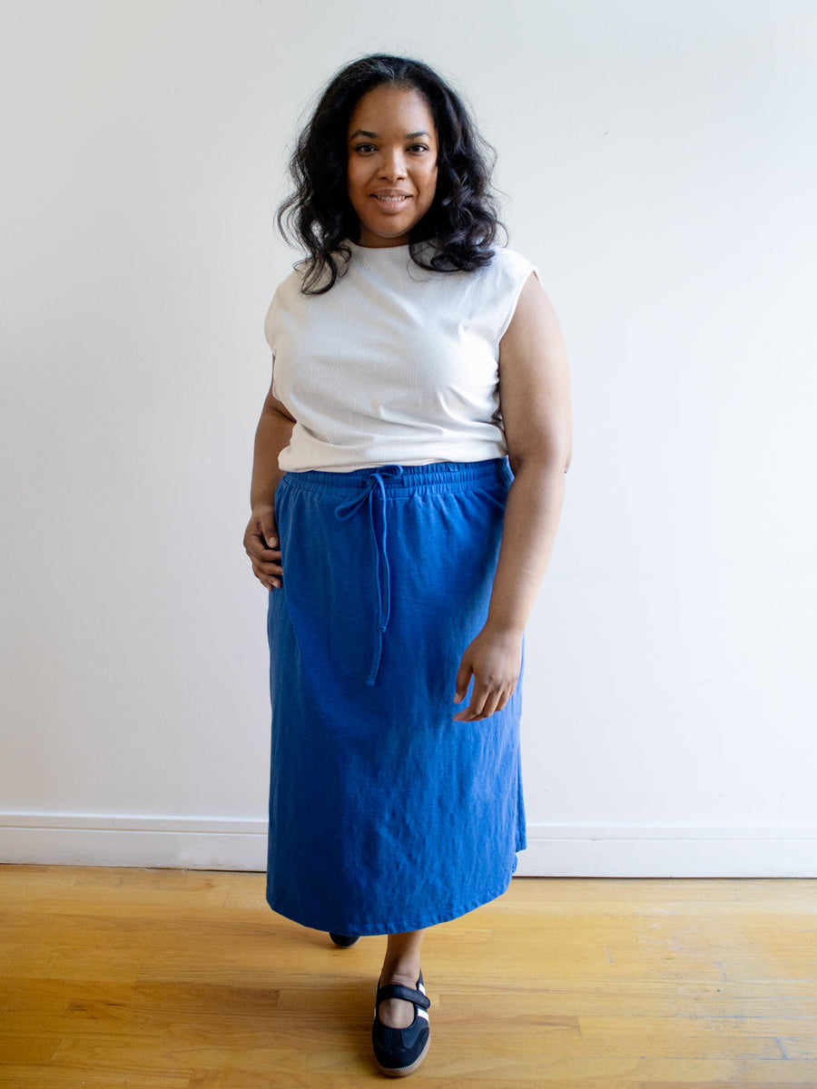 Model wearing the Mata Traders Isla Skirt in cerulean blue organic cotton slub knit.
