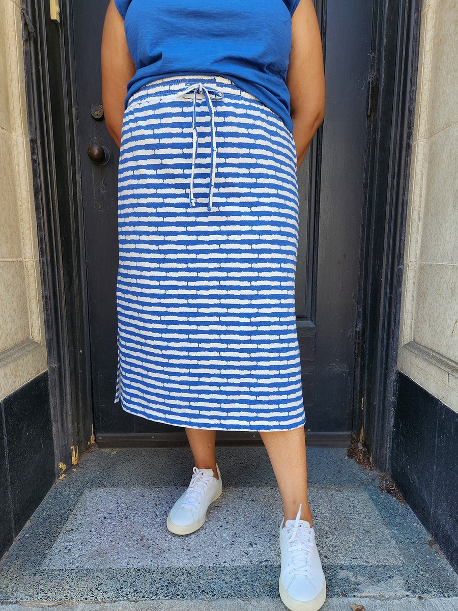 Close-up front view of the cobalt blue striped organic cotton drawstring midi skirt.