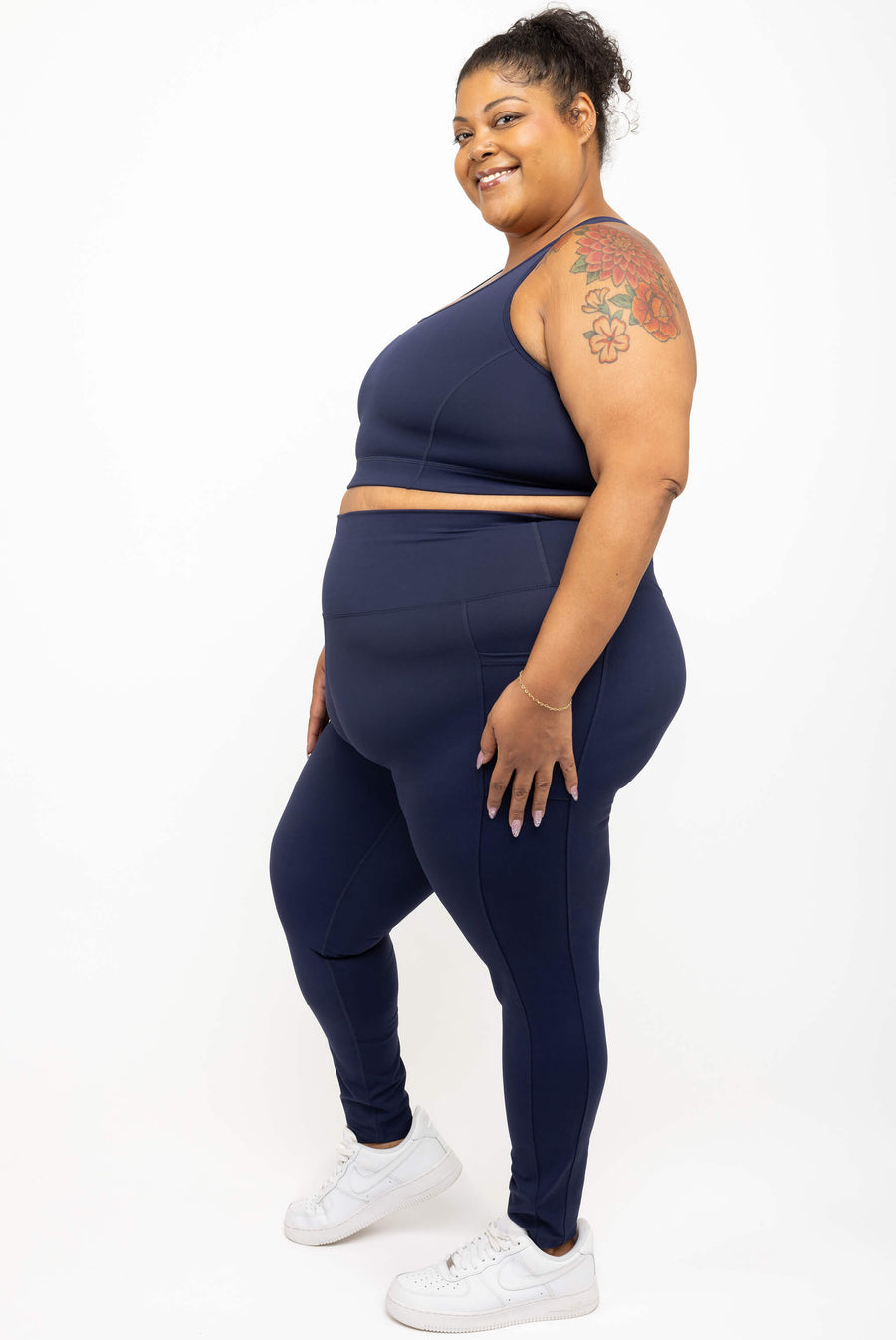Full length view of a plus size woman wearing Superfit Hero navy SuperHold ankle compression leggings  