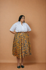 Besida Orange Palm Reversible Wrap Skirt with Pockets styled with a white short-sleeve shirt, front view.