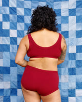 Rear view portrait showing the full back coverage fit of the Tuscan Red organic cotton briefs.