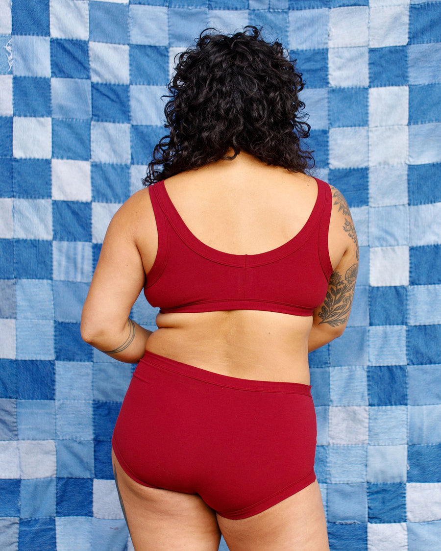 Rear view portrait showing the full back coverage fit of the Tuscan Red organic cotton briefs.
