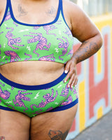Close-up torso view focusing on the high-rise navy waistband and pink tiger print of the briefs.