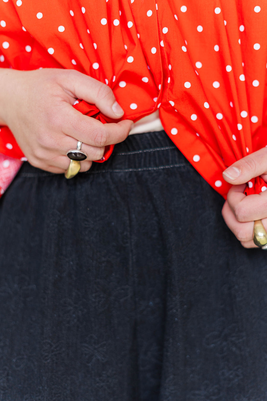 Close-up view of the comfortable elastic waistband on the Nettle Studios Black Daisy Denim Mid Easy Pant.
