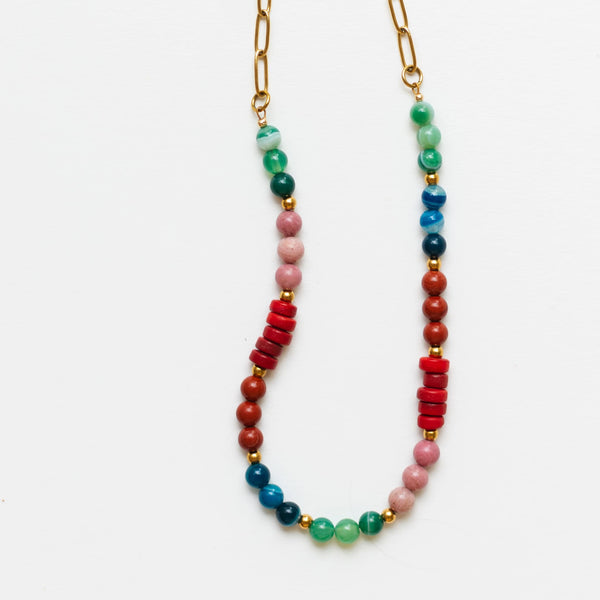 Flat lay product image of the Sela Designs Phoebe Gemstone Necklace showing the colorful jade, jasper, and recycled glass beads attached to a gold paperclip chain