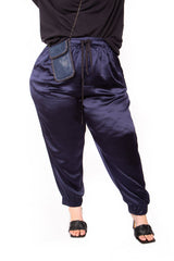 Front cropped view showing the elastic drawstring waist and relaxed fit of the navy blue Italian silk jogger pants.